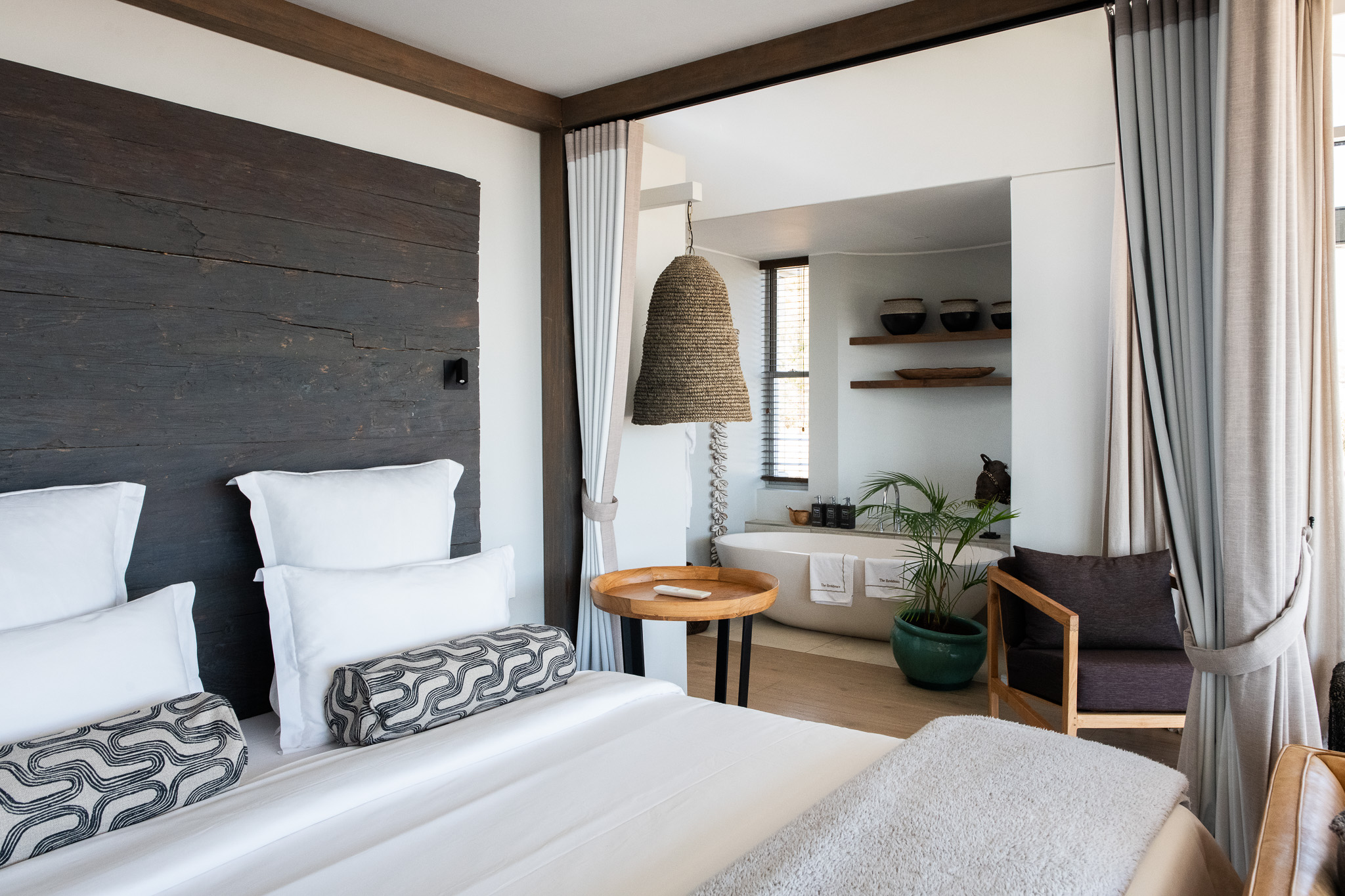 Part of the bed and luxury bath in Lions Head Suite at Atzaró Cape Town hotel.