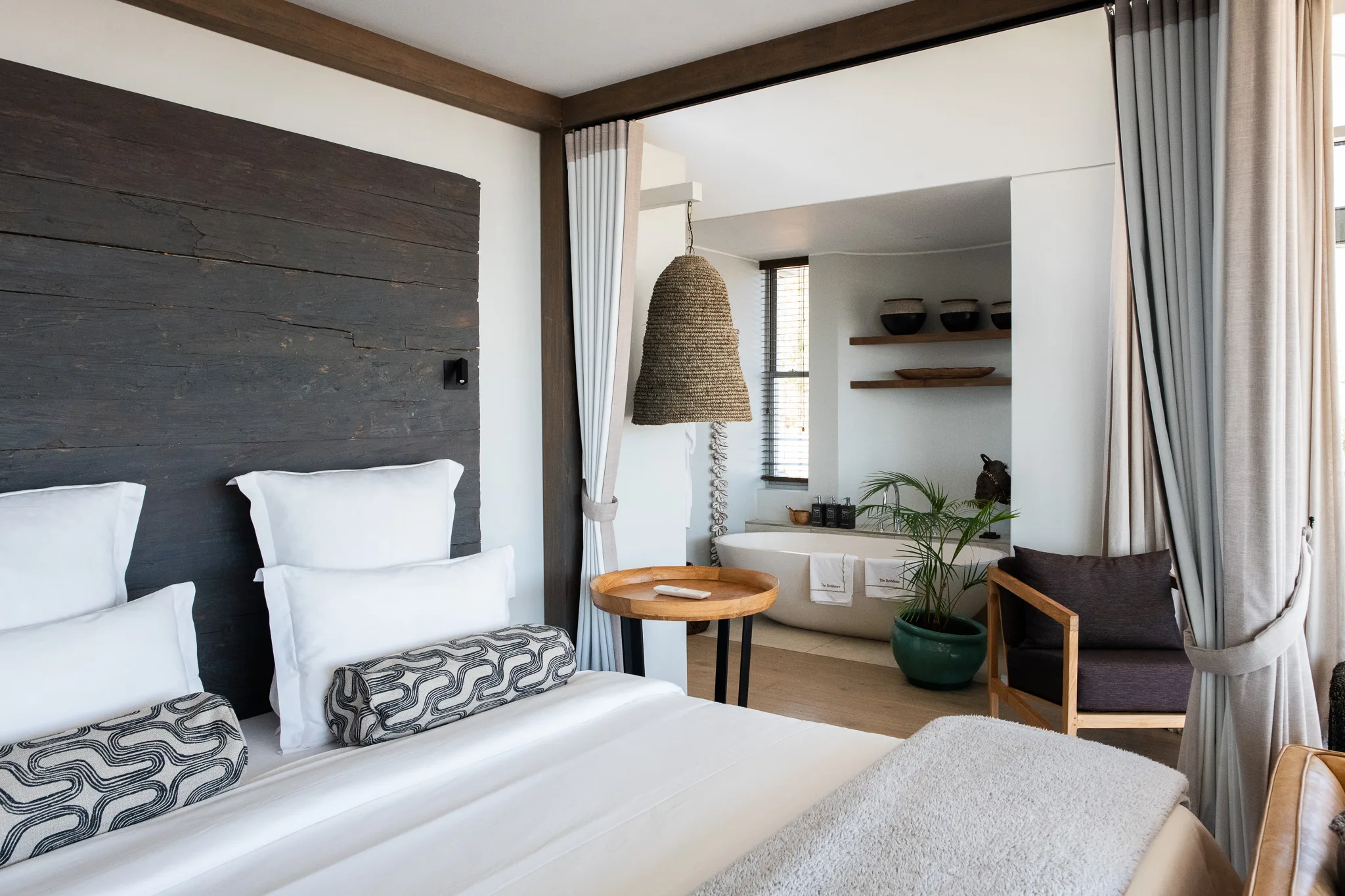 Part of the bed and luxury bath in Lions Head Suite at Atzaró Cape Town hotel.