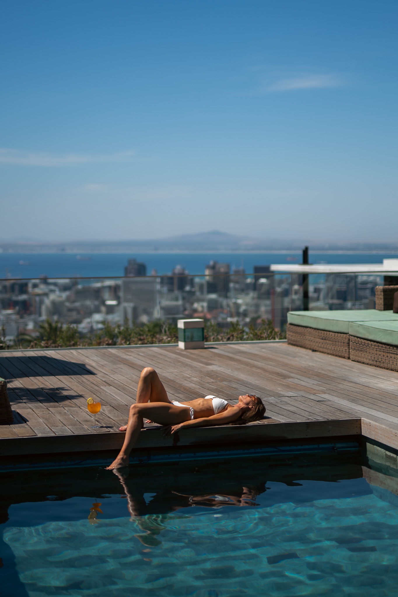 Guest relaxing by the pool at the Atzaro Cape Town luxury boutique hotel in South Africa
