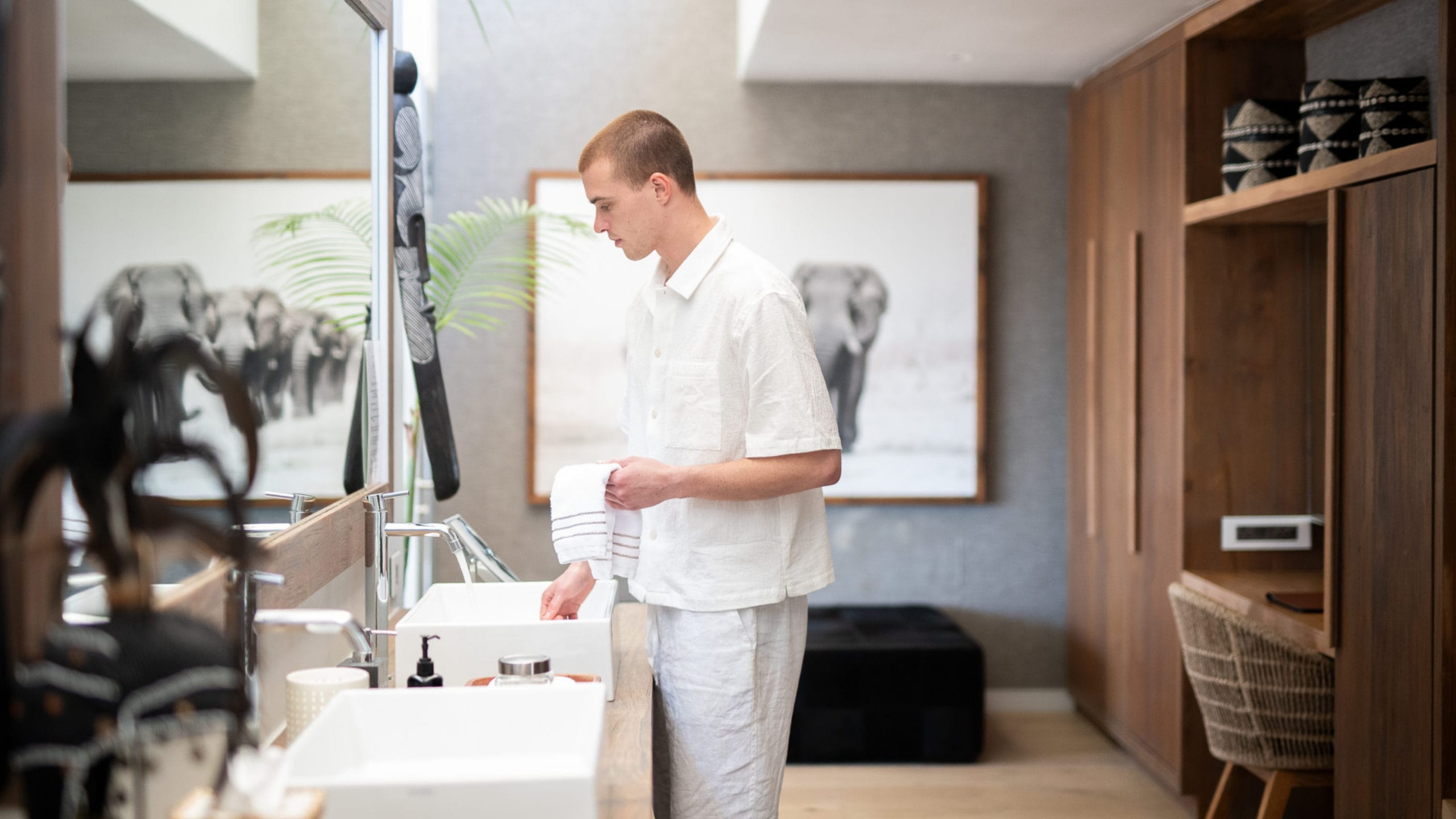Guest in the bathroom of the suite at the luxury boutique hotel Atzaro Cape Town.
